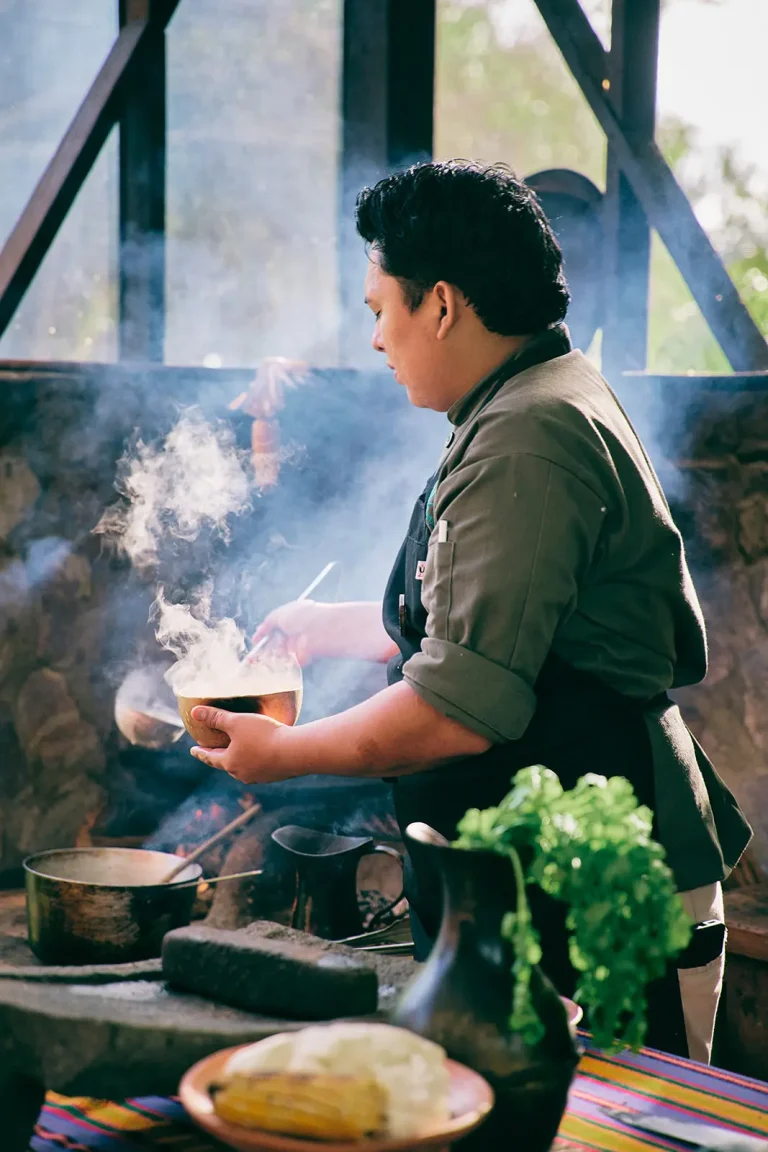 man in authentic belize kitchen giving cooking class