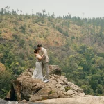 couple kissing with wilderness backdrop